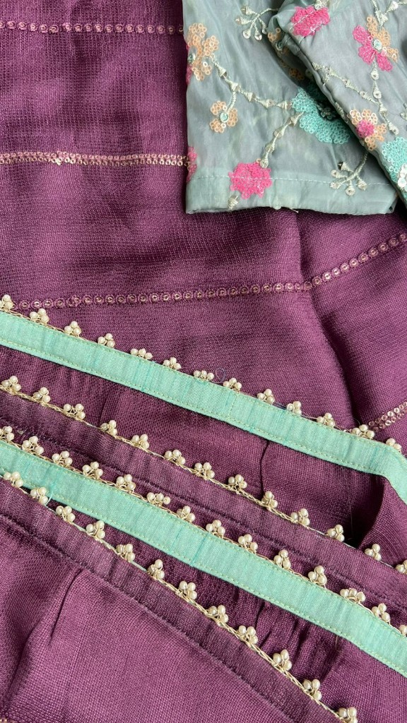 Designer ethnic piece with purple fabric, mint borders, pearls and floral embroidery
