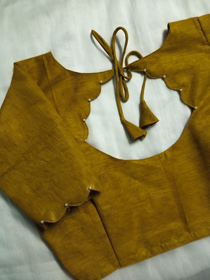 Mustard yellow blouse back with scalloped cutout and pearl accents